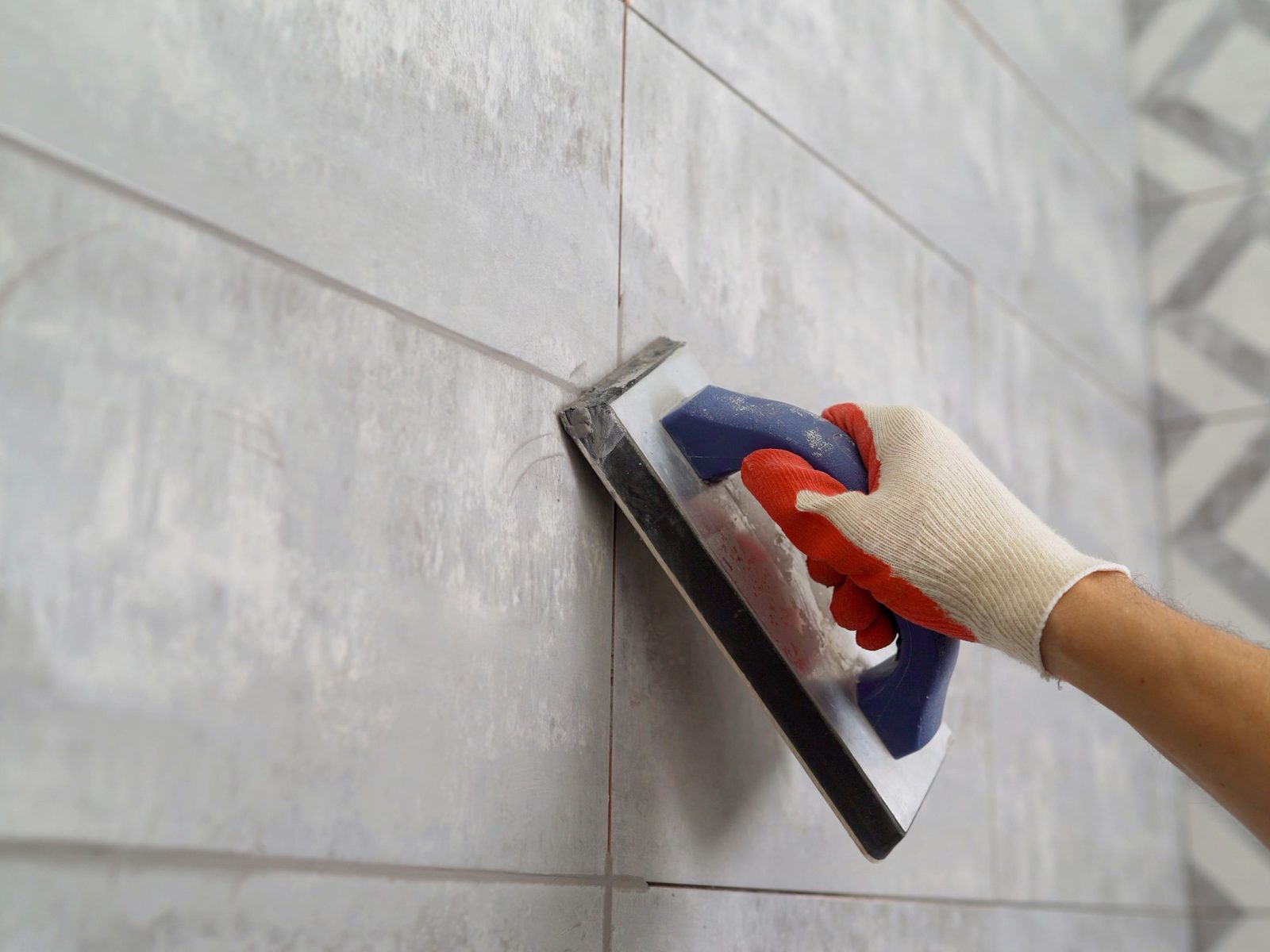Decorative patterned tile with fresh grout lines being finished, Miami