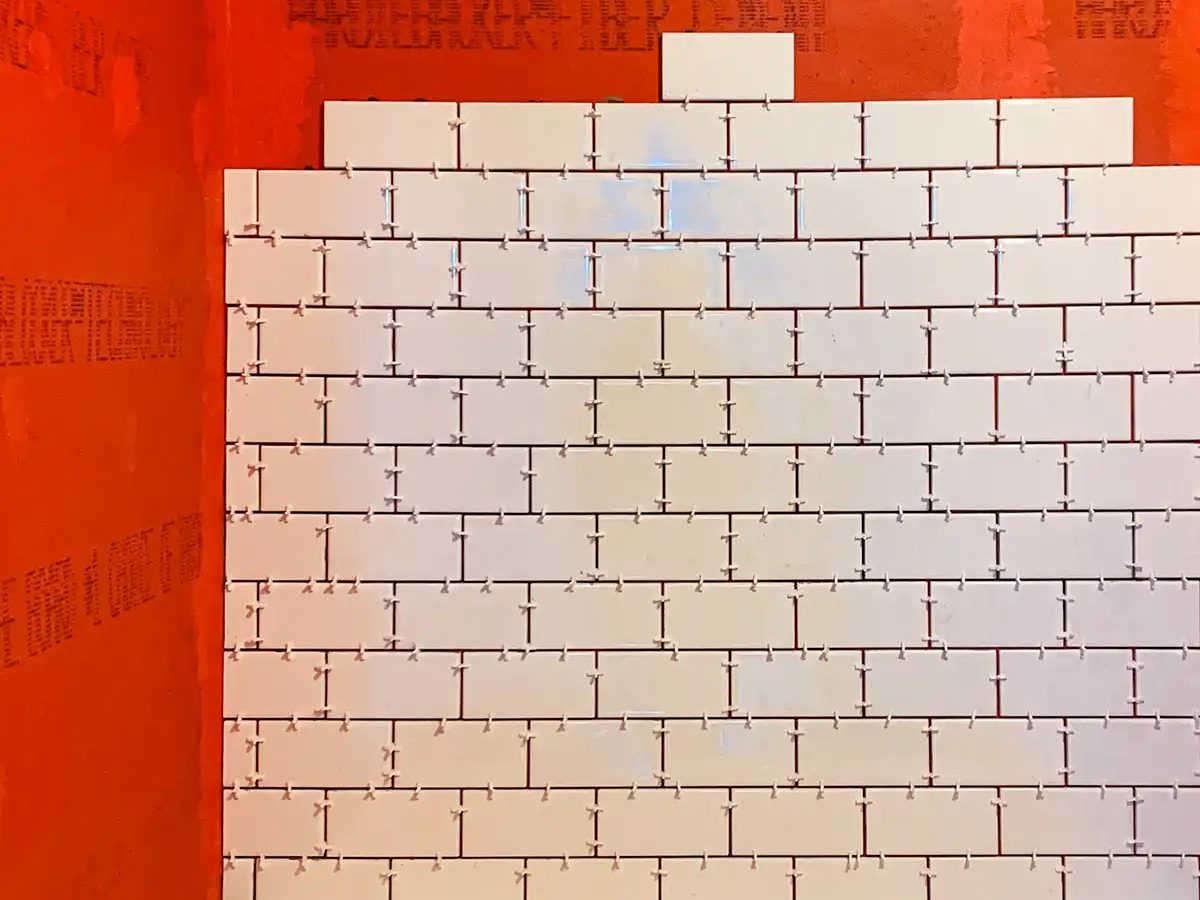 Installer regrouting tile joints with a grout float, Miami